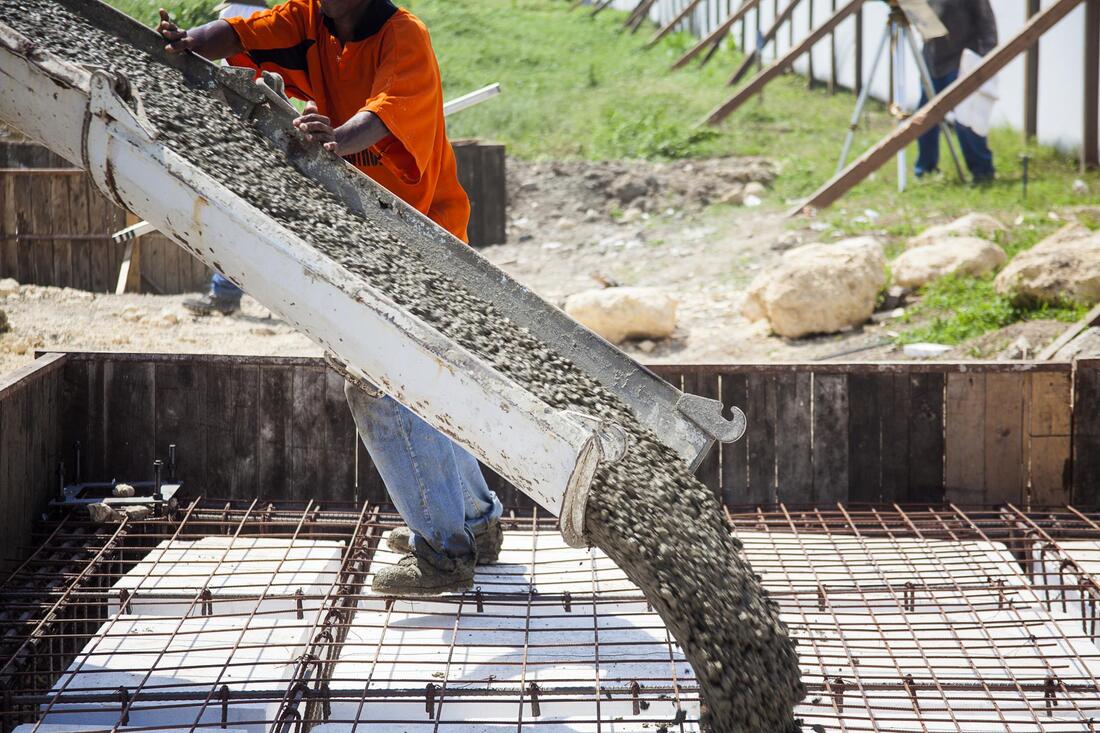 construction worker doing concrete pouring 