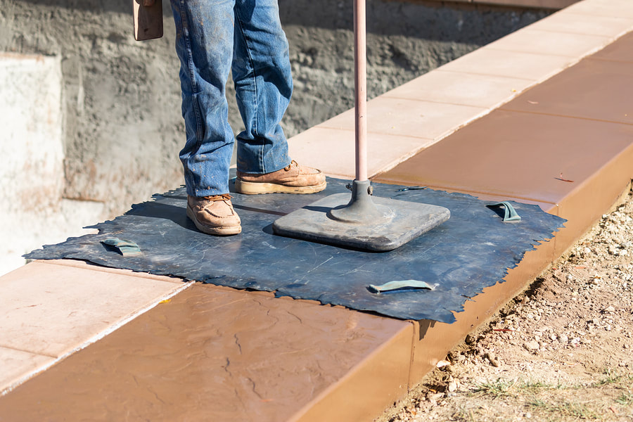 construction worker doing stamped concrete 